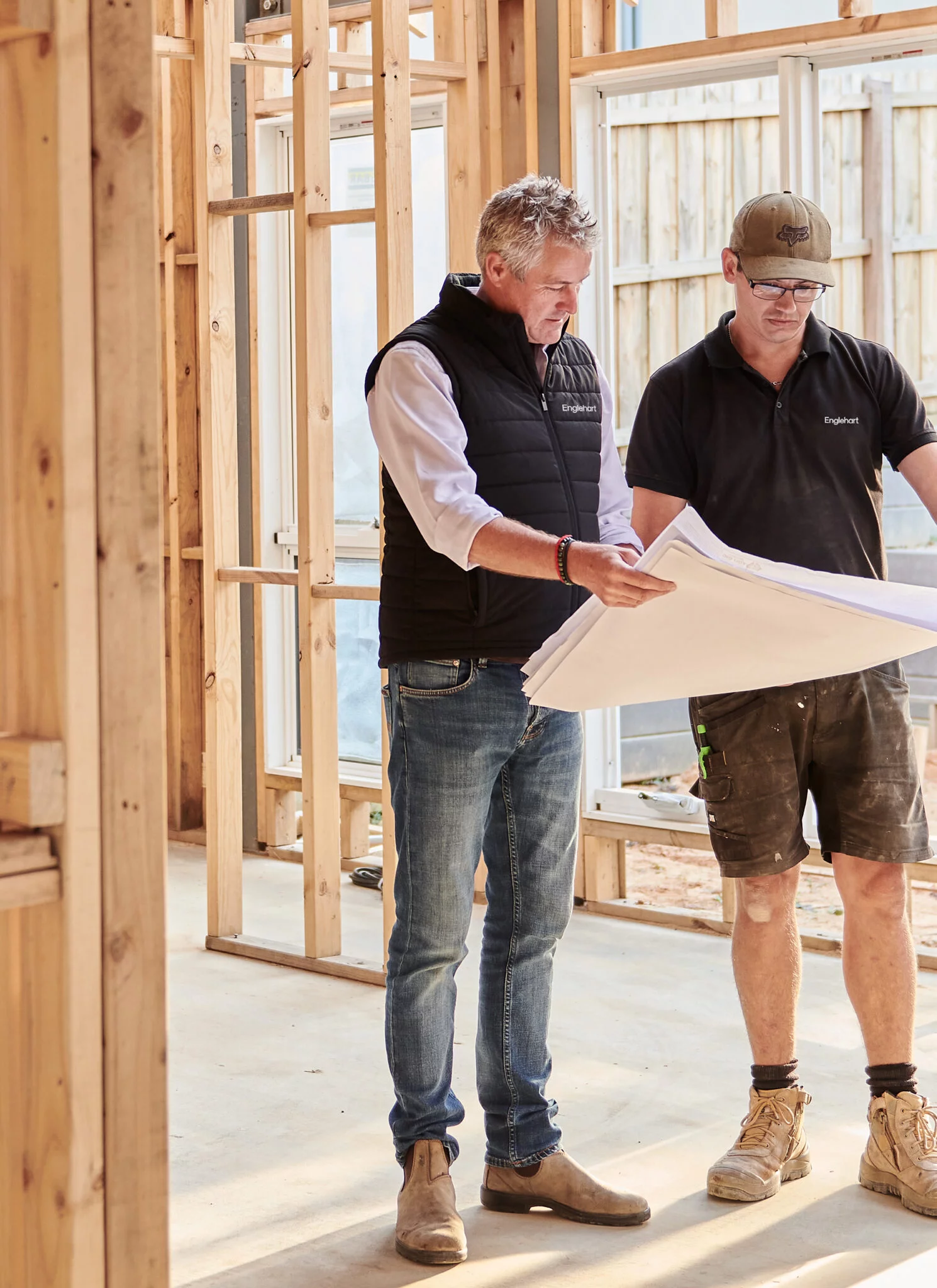 Construction team reviewing building plans on site